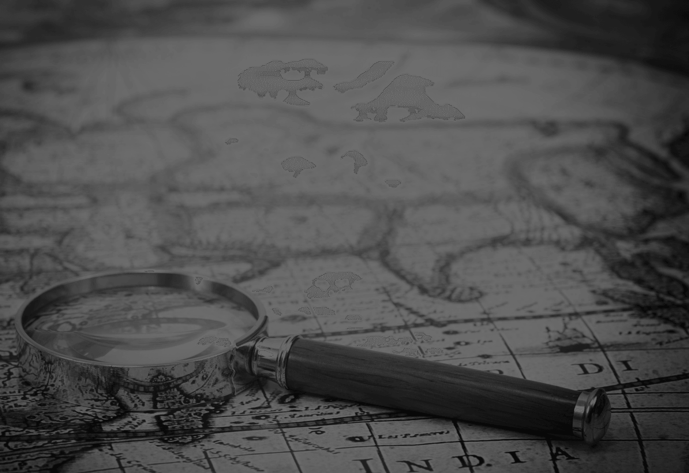 magnifying glass and land surveyor map in black and white