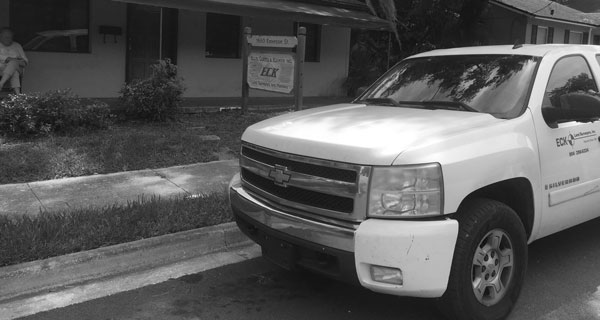 white eck land surveyors, inc truck parked on street