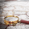 white historical map with magnifying glass